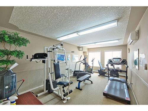 111-550 Prominence Rise Sw, Calgary, AB - Indoor Photo Showing Gym Room