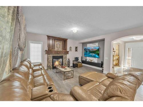 177 Stonemere Close, Chestermere, AB - Indoor Photo Showing Living Room With Fireplace