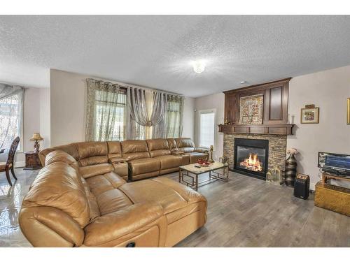 177 Stonemere Close, Chestermere, AB - Indoor Photo Showing Living Room With Fireplace