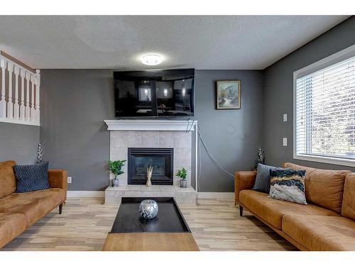 84 Somerset Drive Sw, Calgary, AB - Indoor Photo Showing Living Room With Fireplace