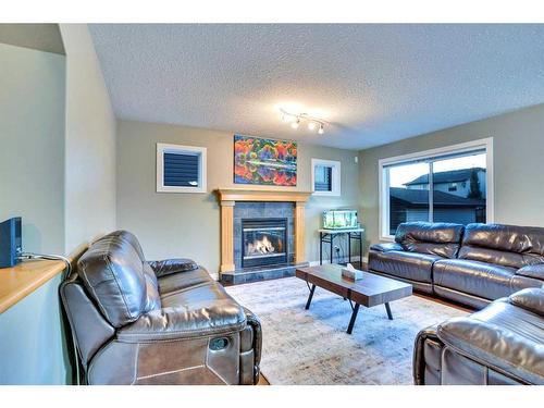 2733 Coopers Circle Sw, Airdrie, AB - Indoor Photo Showing Living Room With Fireplace