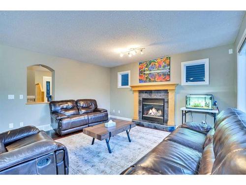 2733 Coopers Circle Sw, Airdrie, AB - Indoor Photo Showing Living Room With Fireplace