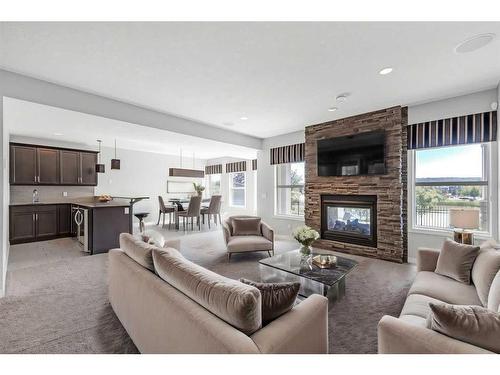 28 Sunset Manor, Cochrane, AB - Indoor Photo Showing Living Room With Fireplace