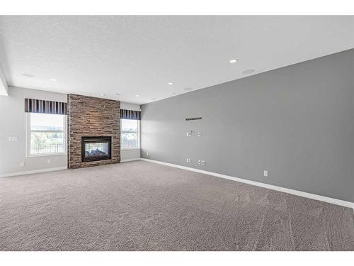 28 Sunset Manor, Cochrane, AB - Indoor Photo Showing Other Room With Fireplace