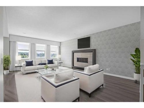 28 Sunset Manor, Cochrane, AB - Indoor Photo Showing Living Room With Fireplace