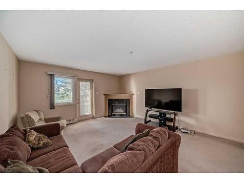 209-790 Kingsmere Crescent Sw, Calgary, AB - Indoor Photo Showing Living Room With Fireplace