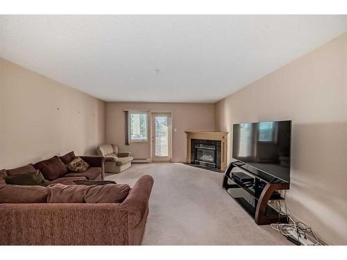 209-790 Kingsmere Crescent Sw, Calgary, AB - Indoor Photo Showing Living Room With Fireplace