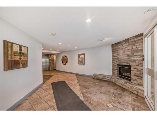 209-790 Kingsmere Crescent Sw, Calgary, AB - Indoor With Fireplace