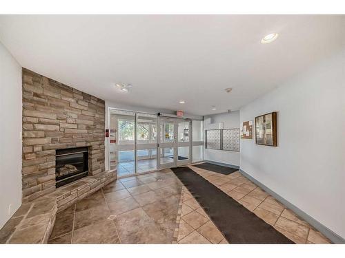 209-790 Kingsmere Crescent Sw, Calgary, AB - Indoor With Fireplace