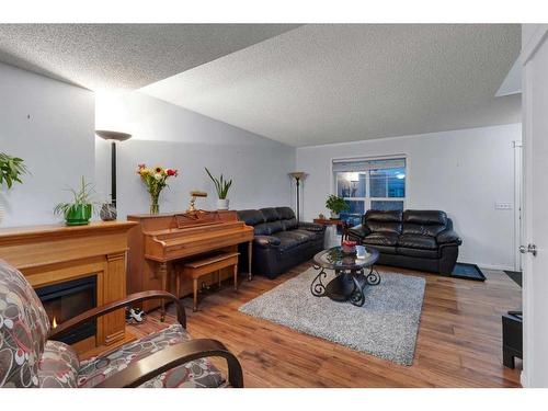 552 Prestwick Circle Se, Calgary, AB - Indoor Photo Showing Living Room With Fireplace