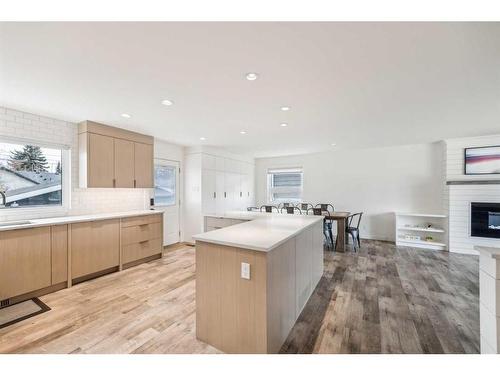 1164 Lake Wapta Road Se, Calgary, AB - Indoor Photo Showing Kitchen With Fireplace