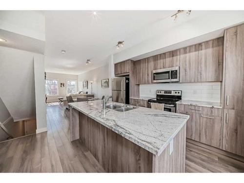 2409 Jumping Pound Common, Cochrane, AB - Indoor Photo Showing Kitchen With Double Sink With Upgraded Kitchen