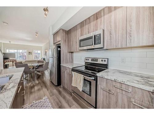 2409 Jumping Pound Common, Cochrane, AB - Indoor Photo Showing Kitchen