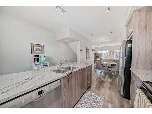 2409 Jumping Pound Common, Cochrane, AB - Indoor Photo Showing Kitchen With Double Sink