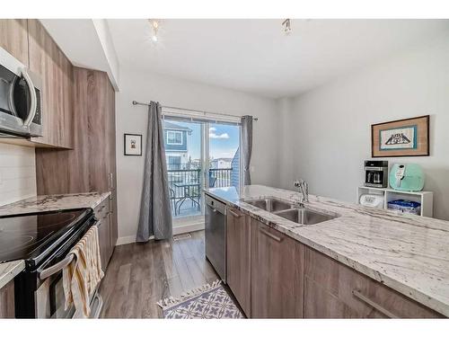 2409 Jumping Pound Common, Cochrane, AB - Indoor Photo Showing Kitchen With Double Sink With Upgraded Kitchen