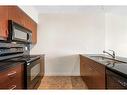 1003-8710 Horton Road Sw, Calgary, AB  - Indoor Photo Showing Kitchen With Double Sink 