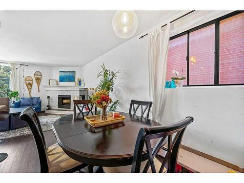 B-518 18 Avenue Sw, Calgary, AB - Indoor Photo Showing Dining Room With Fireplace