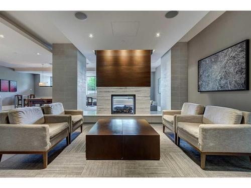 913-222 Riverfront Avenue Sw, Calgary, AB - Indoor Photo Showing Living Room With Fireplace