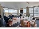 913-222 Riverfront Avenue Sw, Calgary, AB  - Indoor Photo Showing Living Room With Fireplace 