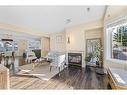 1-2208 29 Street Sw, Calgary, AB  - Indoor Photo Showing Living Room With Fireplace 