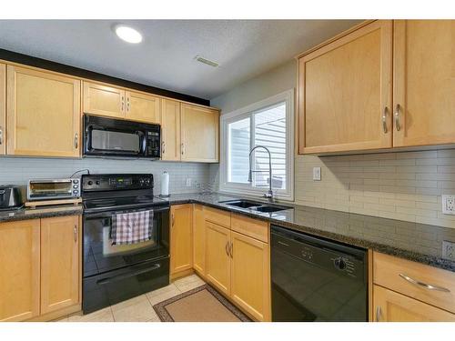 216-34 Glamis Green Sw, Calgary, AB - Indoor Photo Showing Kitchen With Double Sink