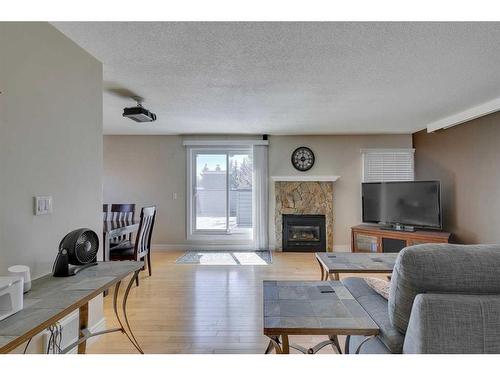 216-34 Glamis Green Sw, Calgary, AB - Indoor Photo Showing Living Room With Fireplace