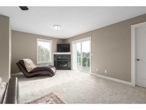 75 West Cedar Rise Sw, Calgary, AB - Indoor Photo Showing Living Room With Fireplace