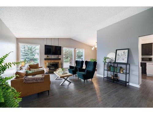 243 Cedarbrae Crescent Sw, Calgary, AB - Indoor Photo Showing Living Room With Fireplace