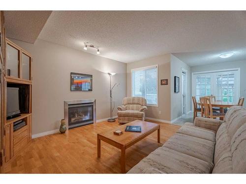 94 Cougar Plateau Way Sw, Calgary, AB - Indoor Photo Showing Living Room With Fireplace