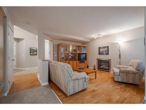 94 Cougar Plateau Way Sw, Calgary, AB - Indoor Photo Showing Living Room With Fireplace