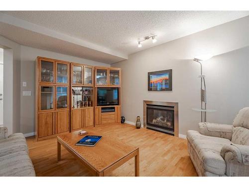 94 Cougar Plateau Way Sw, Calgary, AB - Indoor Photo Showing Living Room With Fireplace