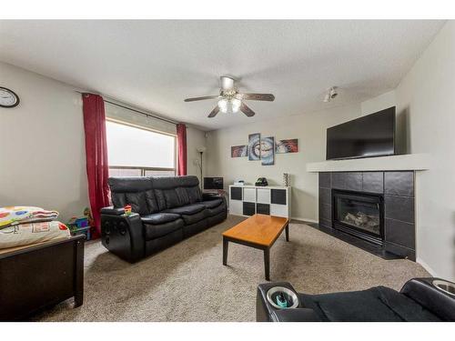 256 Oakmere Place, Chestermere, AB - Indoor Photo Showing Living Room With Fireplace