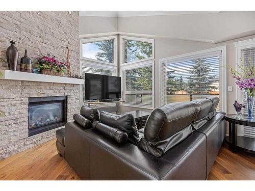 60 Cougar Ridge Landing Sw, Calgary, AB - Indoor Photo Showing Living Room With Fireplace