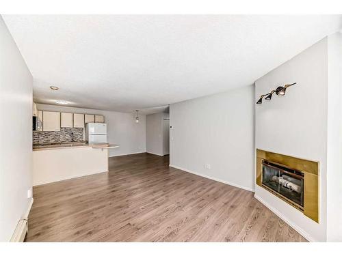 12-2812 Edenwold Heights Nw, Calgary, AB - Indoor Photo Showing Living Room With Fireplace