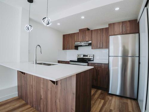 305-156 Park Street, Cochrane, AB - Indoor Photo Showing Kitchen With Stainless Steel Kitchen With Double Sink With Upgraded Kitchen