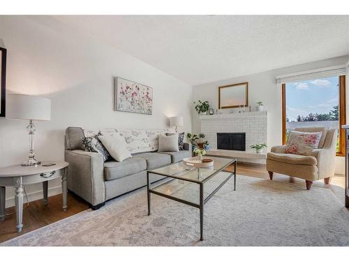 348 Weddenburn Road Se, Calgary, AB - Indoor Photo Showing Living Room With Fireplace