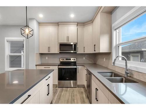 105 Midtown Close Sw, Airdrie, AB - Indoor Photo Showing Kitchen With Double Sink