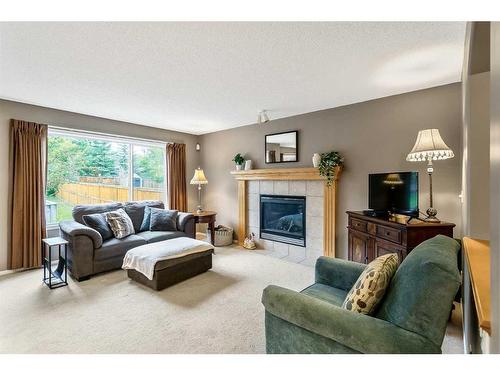 168 Bridlepost Green Sw, Calgary, AB - Indoor Photo Showing Living Room With Fireplace