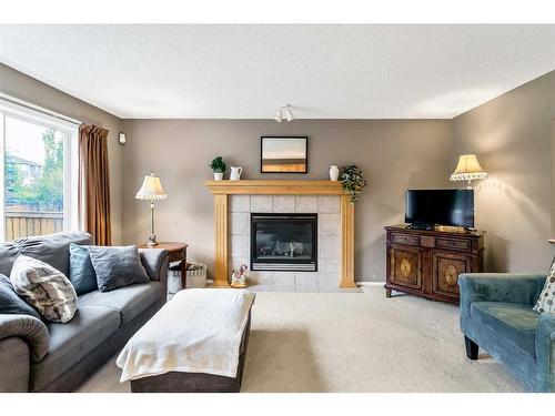 168 Bridlepost Green Sw, Calgary, AB - Indoor Photo Showing Living Room With Fireplace