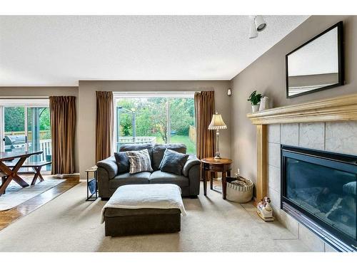 168 Bridlepost Green Sw, Calgary, AB - Indoor Photo Showing Living Room With Fireplace