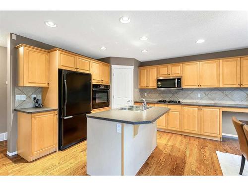 168 Bridlepost Green Sw, Calgary, AB - Indoor Photo Showing Kitchen With Double Sink