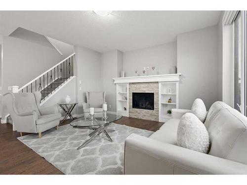 566 Silverado Boulevard Sw, Calgary, AB - Indoor Photo Showing Living Room With Fireplace