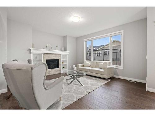 566 Silverado Boulevard Sw, Calgary, AB - Indoor Photo Showing Living Room With Fireplace