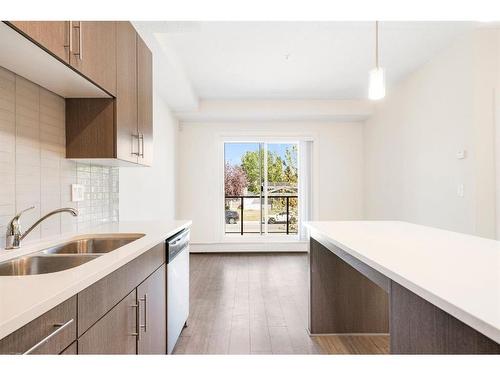 205-15233 1 Street Se, Calgary, AB - Indoor Photo Showing Kitchen With Double Sink