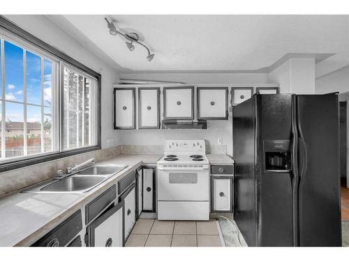 215 Rundlecairn Road Ne, Calgary, AB - Indoor Photo Showing Kitchen With Double Sink