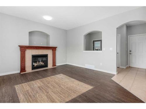 793 Luxstone Landing Sw, Airdrie, AB - Indoor Photo Showing Living Room With Fireplace