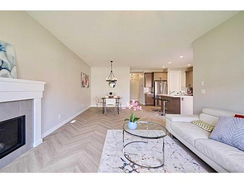 48 Shawnee Green Sw, Calgary, AB - Indoor Photo Showing Living Room With Fireplace