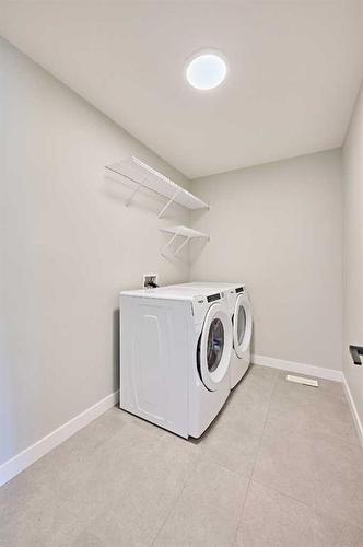 48 Shawnee Green Sw, Calgary, AB - Indoor Photo Showing Laundry Room