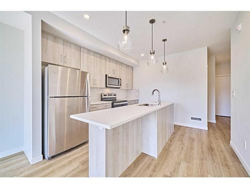 504-71 Shawnee Common Sw, Calgary, AB - Indoor Photo Showing Kitchen With Stainless Steel Kitchen With Upgraded Kitchen