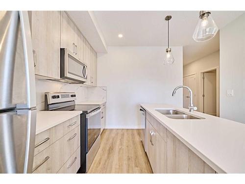 504-71 Shawnee Common Sw, Calgary, AB - Indoor Photo Showing Kitchen With Double Sink